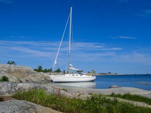 Sailboat moored at small rocky island in the outer part of the archipelago of Stockholm, Sweden