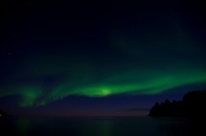 An aurora is a natural light display in the sky, predominantly seen in the high latitude Arctic and Antarctic regions.
